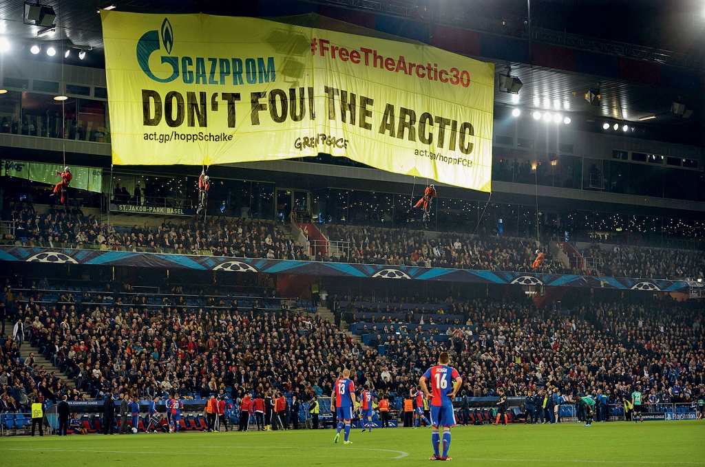 Greenpeace activists unfurl banner during a game of the League of Champions 1 October 2013. Gazprom is the official sponsor of the Munich team Schalke 04.