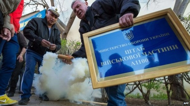 Pro-Russian activists threw smoke bombs before storming the base in Novofedorivka | AFP