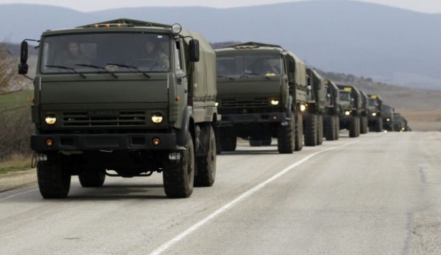 A convoy of military vehicles bearing no license plates travels on the road from Feodosia to Simferopol in the Crimea, Ukraine, Saturday, March 8, 2014. Photo by AP