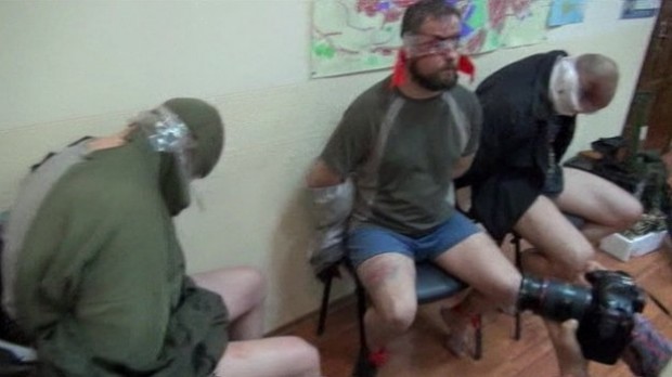 A picture, released by separatists, show three captured Ukrainian officers, bloodied and blindfolded