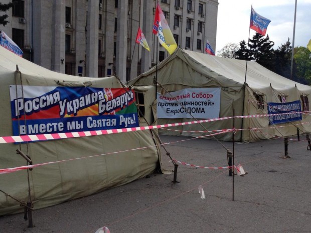 Tents in Odessa 1 May 2014. Photo by Max Motin. Signs: (L)  Russia, Ukraine, Belarus Together We Are Sacred Rus' (C) Popular Assembly Against the "Values" of EuroSodom (R) Union of Orthodox Citizens of Ukraine 