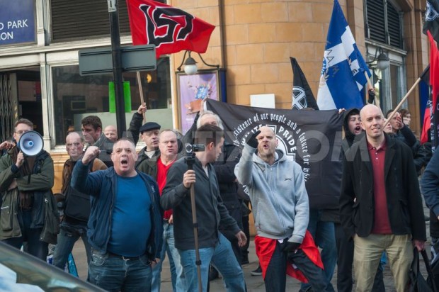 Jeremy "Jez" Bedford-Turner (a man with a loud-speaker on the left), Eddy Stampton (a man in a cap), and Piers Mellor at a demonstration in support of the neo-Nazi Golden Dawn, 29 November 2015, London